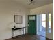 Inviting entryway with modern lighting, decorative console table and open green door at 2561 Red Rock Dr, Pahrump, NV 89048