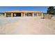 Unfinished home with plywood exterior, large windows, and a spacious three-car garage at 2561 Red Rock Dr, Pahrump, NV 89048