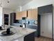 Modern kitchen featuring two-tone cabinets, stainless steel appliances, and island with a marble countertop at 2561 Red Rock Dr, Pahrump, NV 89048