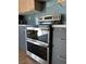 Stainless steel double oven with sleek gray cabinetry and hardware against a teal backsplash at 2561 Red Rock Dr, Pahrump, NV 89048