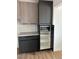 Kitchen storage unit featuring gray and wood cabinets, with a microwave inside at 2561 Red Rock Dr, Pahrump, NV 89048