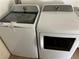 Modern laundry room with white front load washer and dryer set, offering convenience at 2561 Red Rock Dr, Pahrump, NV 89048