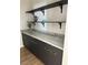 Storage area showcasing sleek, dark cabinets with bronze pulls and open shelving at 2561 Red Rock Dr, Pahrump, NV 89048