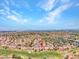 Aerial view of a community on a golf course, with red tile roofs and desert flora creating a unique landscape at 2829 Golf Links Dr, Las Vegas, NV 89134