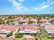 Bird's-eye view of a neighborhood with houses featuring red tile roofs surrounded by mature trees and desert flora at 2829 Golf Links Dr, Las Vegas, NV 89134