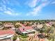 An aerial perspective of a community with a cluster of homes with terra cotta roofs surrounded by greenery at 2829 Golf Links Dr, Las Vegas, NV 89134