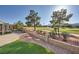Landscaped backyard with golf course views, synthetic grass, and a stone pathway at 2829 Golf Links Dr, Las Vegas, NV 89134