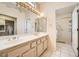 Bright bathroom featuring double sinks, walk-in shower, and a neutral color palette at 2829 Golf Links Dr, Las Vegas, NV 89134