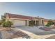 Well-maintained single-story home featuring a two-car garage, desert landscaping, and a terracotta roof at 2829 Golf Links Dr, Las Vegas, NV 89134