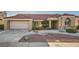 Inviting single-story home with a spacious driveway, two-car garage, and desert-style landscaping at 2829 Golf Links Dr, Las Vegas, NV 89134