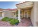 Welcoming front porch with tiled walkway, decorative shrubbery, and a charming exterior light fixture at 2829 Golf Links Dr, Las Vegas, NV 89134