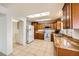 Bright kitchen featuring granite countertops, tile flooring, wood cabinets and skylights at 2829 Golf Links Dr, Las Vegas, NV 89134