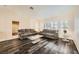 Cozy living room with wood-look flooring, plush sofas, and abundant natural light from plantation shutters at 2829 Golf Links Dr, Las Vegas, NV 89134