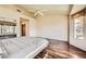 Main bedroom with mirrored closets, vaulted ceilings, and a bright window view at 2829 Golf Links Dr, Las Vegas, NV 89134
