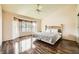 Comfortable main bedroom features wood floors, large windows, and a ceiling fan at 2829 Golf Links Dr, Las Vegas, NV 89134