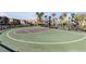 Outdoor community basketball court with green surface, backboard, and playground in the background at 2846 Cerulean Stars Ln # 1, Las Vegas, NV 89183