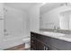 Bathroom featuring shower and tub combo and dark wood cabinets at 2846 Cerulean Stars Ln # 1, Las Vegas, NV 89183