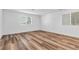 Spacious bedroom with wood-look flooring, white walls and natural light from two windows at 2846 Cerulean Stars Ln # 1, Las Vegas, NV 89183
