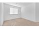 Bright bedroom features neutral carpet, a window, and white walls at 2846 Cerulean Stars Ln # 1, Las Vegas, NV 89183
