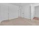 Spacious bedroom with neutral carpet, white walls, and ensuite bathroom entry at 2846 Cerulean Stars Ln # 1, Las Vegas, NV 89183