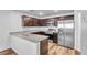 Modern kitchen with stainless steel appliances, granite counters, and dark wood cabinets at 2846 Cerulean Stars Ln # 1, Las Vegas, NV 89183