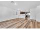 Bright and airy living area showcasing wood-look floors and a seamless flow to the kitchen at 2846 Cerulean Stars Ln # 1, Las Vegas, NV 89183