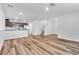 Open-concept living space featuring wood-look floors, modern kitchen, and staircase access at 2846 Cerulean Stars Ln # 1, Las Vegas, NV 89183