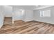 Bright living room with modern flooring, white walls and staircase leading to the second floor at 2846 Cerulean Stars Ln # 1, Las Vegas, NV 89183