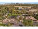 Elevated view showcasing the home, lush landscaping, pool, and the Las Vegas skyline in the background at 3004 Astoria Pines Cir, Las Vegas, NV 89107