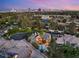 Expansive aerial view of the estate showcasing the home, pool, lush landscaping, and city skyline at 3004 Astoria Pines Cir, Las Vegas, NV 89107