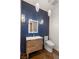 Contemporary powder room featuring a vanity with modern sink and toilet, illuminated mirror, and unique lighting at 3004 Astoria Pines Cir, Las Vegas, NV 89107