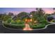 An eye-level shot of a single-story home with a red door and lush landscaping at 3004 Astoria Pines Cir, Las Vegas, NV 89107