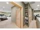 Hallway with built-in shelves leads to bedroom featuring a bed, desk, and outdoor access at 3004 Astoria Pines Cir, Las Vegas, NV 89107