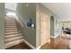 Hallway featuring a staircase and glossy floors that lead to an open living space with natural light at 3004 Astoria Pines Cir, Las Vegas, NV 89107