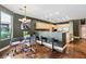 A partial view of a kitchen including a bar, bar stools and adjacent dining area at 3004 Astoria Pines Cir, Las Vegas, NV 89107