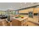 Spacious kitchen featuring an island, stainless steel appliances, and bright lighting at 3004 Astoria Pines Cir, Las Vegas, NV 89107