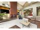 Comfortable living room with a modern fireplace, accent lighting, and brown leather seating at 3004 Astoria Pines Cir, Las Vegas, NV 89107