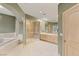 Large main bathroom featuring a soaking tub, a walk-in shower, and double sink vanity at 3004 Astoria Pines Cir, Las Vegas, NV 89107