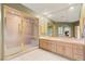 Elegant bathroom with a large glass shower, double vanity, and a view of the fireplace at 3004 Astoria Pines Cir, Las Vegas, NV 89107