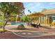 Backyard oasis featuring a pool, lush landscaping, outdoor dining, and lounge seating at 3004 Astoria Pines Cir, Las Vegas, NV 89107