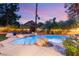 Tranquil twilight scene of a backyard pool with lush landscaping and comfortable seating area at 3004 Astoria Pines Cir, Las Vegas, NV 89107
