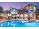 Twilight scene of a backyard pool and spa area, complete with lounge chairs and lush landscaping at 3004 Astoria Pines Cir, Las Vegas, NV 89107