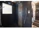 Modern shower featuring a unique tile design, multiple shower heads and handheld sprayer at 3004 Astoria Pines Cir, Las Vegas, NV 89107