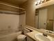 Modest bathroom featuring a tiled bathtub and shower combo, vanity with sink and standard light fixture at 3151 Soaring Gulls Dr # 2147, Las Vegas, NV 89128