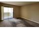 A bright, carpeted bedroom with a sliding glass door leading to an outdoor balcony at 3151 Soaring Gulls Dr # 2147, Las Vegas, NV 89128