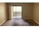 A bright, carpeted bedroom with a sliding glass door leading to an outdoor balcony at 3151 Soaring Gulls Dr # 2147, Las Vegas, NV 89128