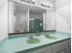 Bathroom featuring double sinks with teal countertops, a large mirror, and retro style at 3212 Silver Saddle St, Las Vegas, NV 89169