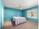 Bright bedroom showcases a ceiling fan, carpet floors, large closets, and unique blue walls at 3212 Silver Saddle St, Las Vegas, NV 89169
