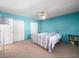 Bright bedroom showcases a ceiling fan, carpet floors, large closets, and unique blue walls at 3212 Silver Saddle St, Las Vegas, NV 89169