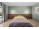 Comfortable bedroom with an accent wall, window, and modern lighting at 3212 Silver Saddle St, Las Vegas, NV 89169